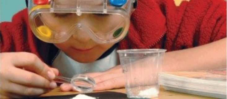 A young student inspecting a chemical substance